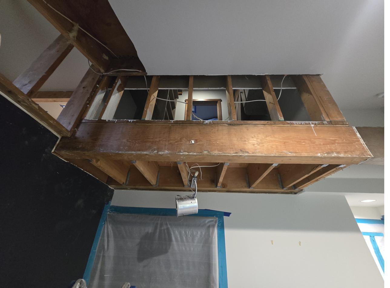 Ceiling demolition exposing framing during a remediation project, no people in frame