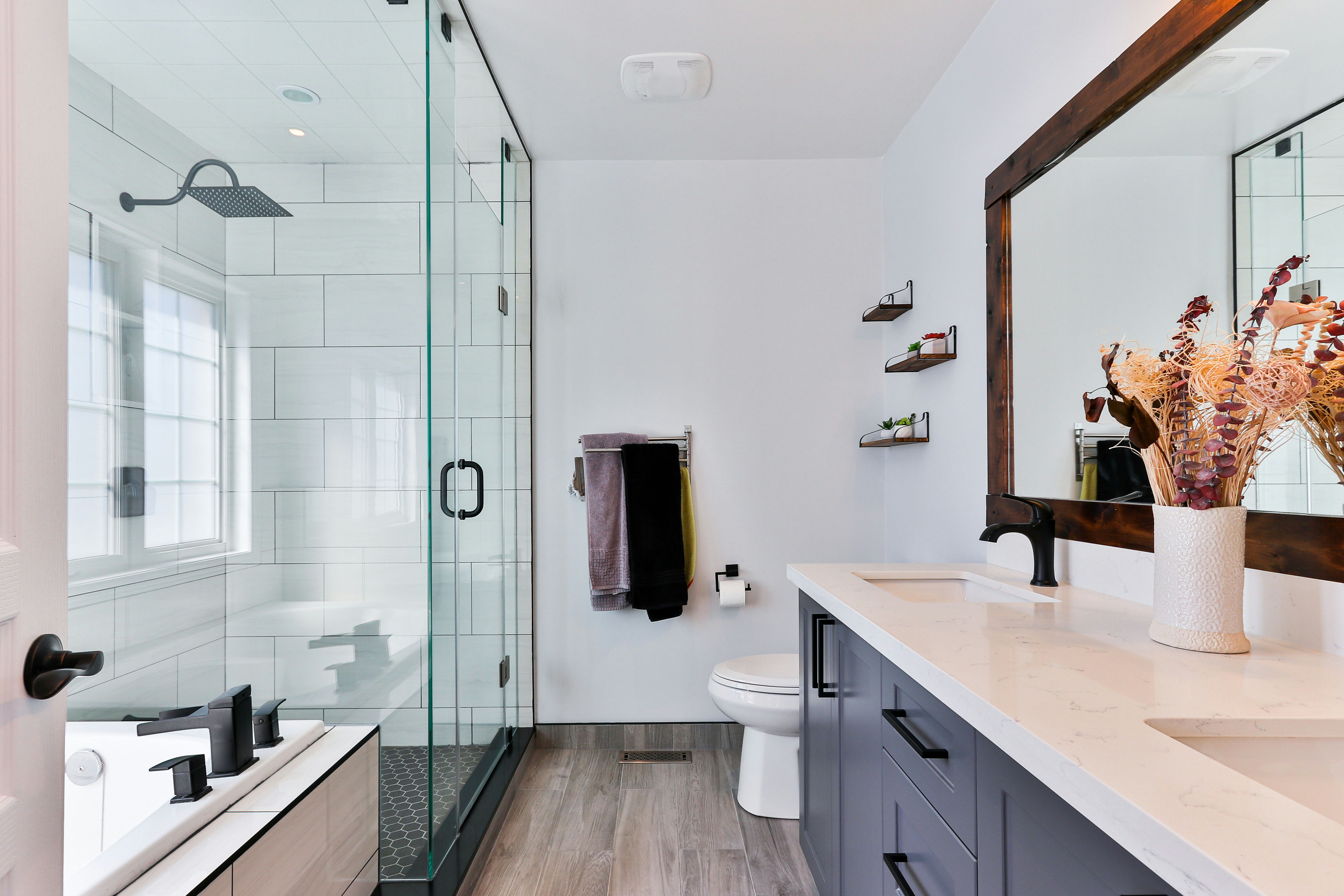 A modern bathroom with glass shower, restored after source remediation